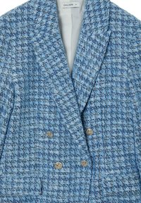 Double-breasted blazer in a textured blue fabric featuring varied blue tones and silver-toned hardware. Lined interior with notched lapels.