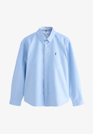 Lyseblå skjorte med knapper, lavet af et glat stof. Har krave, lange ærmer og en lille broderet logo på brystet.