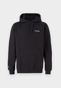 Sweat à capuche noir en tissu doux. Doté d'une poche kangourou, de poignets côtelés et du logo "SALOMON" en blanc sur la poitrine.