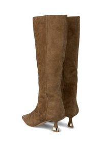 Botas altas de ante marrón con punta afilada, diseño elegante y único tacón acampanado con un acento metálico en la base.