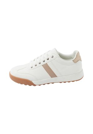 White sneaker with beige stripes, beige heel patch, white laces, and brown rubber sole with textured grip.