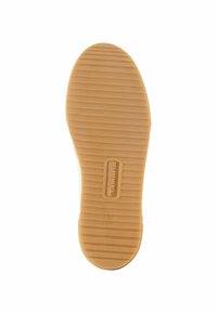 Tan rubber shoe sole with vertical grooves, embossed logo "Tamaris," size "37," and "Made in Portugal" label.
