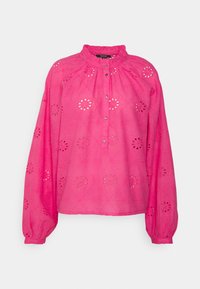 Blusa rosa com decote franzido, frente com botões e padrões de flores recortados. Mangas longas e soltas com punhos franzidos.