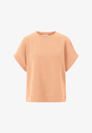 Sweat-shirt à manches courtes de couleur pêche, col rond, avec des poignets retroussés et un ourlet droit.