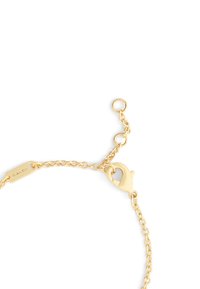 Gold chain bracelet with a lobster claw clasp. Chain features interlinked segments and a small tag engraved with "COACH."