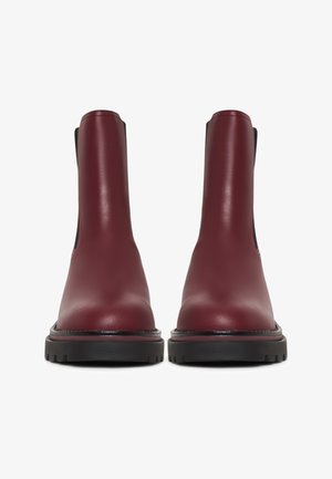 Stivaletti in pelle bordeaux con finitura liscia, suola in gomma nera, pannelli laterali elasticizzati e punta rotonda.