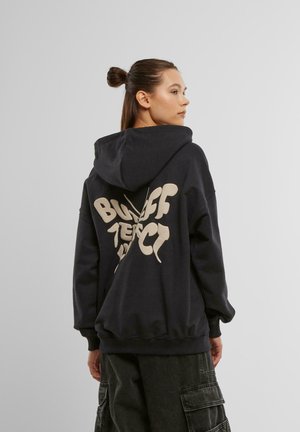 Black hoodie with a large cream graphic reading "Bigger Perfect" on the back. Features a drawstring hood and ribbed cuffs.