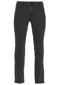 Mustat farkut, joissa on istuva muotoilu. Keskikorkea vyötärö, viisi taskua, yksittäinen napitus ja hienovarainen kuluminen kankaassa.