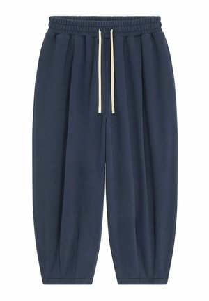 Pantalon de survêtement bleu marine avec taille élastique, cordons blancs, poches latérales et jambes fuselées.