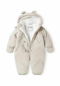 Salopetă de iarnă pentru bebeluși, bej, căptușită, cu închidere cu fermoar, glugă și urechi de urs. Prezintă manșete elastice și cusături diagonale texturate. Interior căptușit.