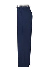 Marineblauwe broek met een losse pasvorm, voorzien van een witte elastische tailleband en zijzakken. Gladde stof met een getailleerd silhouet.