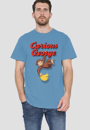 Man wearing a blue t-shirt with red "Curious George" text and an illustrated monkey holding a bunch of bananas.