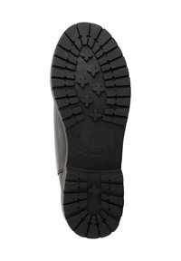 Zwarte rubberen zool met diepe loopprofielen en kruisvormige grip, maat 39, gelabeld 'Travelin' op de onderkant van een laars.