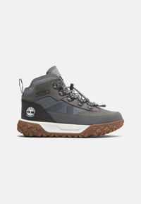 Gray waterproof hiking boot with a textured shaft, rubber sole, and brown tread. Features lace-up design and logo on the side.