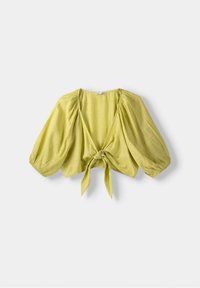 Blusa cropped verde lime con maniche a sbuffo, scollo a V e dettaglio con fiocco frontale. Realizzata in tessuto leggero e texture.