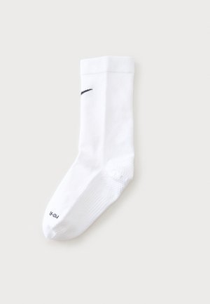 Chaussette de sport blanche unique avec logo noir près du bord-côte et texte "PRO-R" sur l'orteil, affichée à plat sur un fond clair.