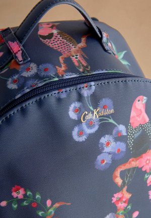 Navy fabric bag with floral and bird patterns. Gold brand logo "Cath Kidston" on zipper, textured surface with a glossy finish.