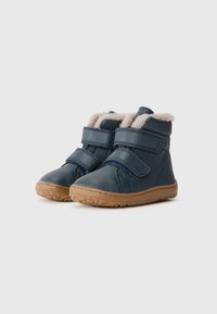 Donkerblauwe leren laarzen met twee klittenbandsluitingen, gevoerd met lichtgekleurde nepbont, en een rubberen zool met een gestructureerd grippatroon.