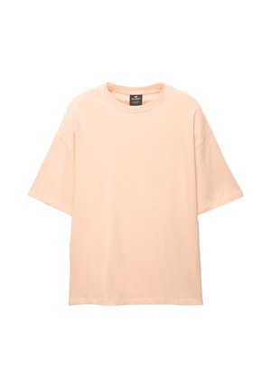 Tricou oversized de culoare piersica, fabricat din bumbac moale. Are un guler rotund și mâneci scurte, căzute, fără modele sau embellishments.