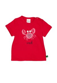 Červené bavlněné tričko s grafikou růžové krabice, která má oči, tečky a slovo "krab" pod ní. Zapínání na patentky na rameni.