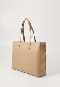 Tan leather tote bag with rectangular shape, two narrow handles, minimalistic design, and smooth texture, suitable for everyday use.