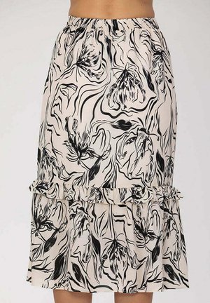 Jupe crème avec motif floral abstrait noir, taille élastique et détail à volants près de l'ourlet.