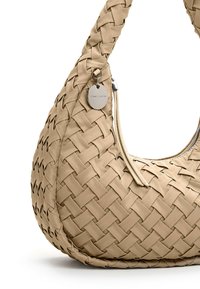 Beige woven handbag with a rounded shape, textured surface, and silver hardware detailing. Features a zip closure and a hanging charm.