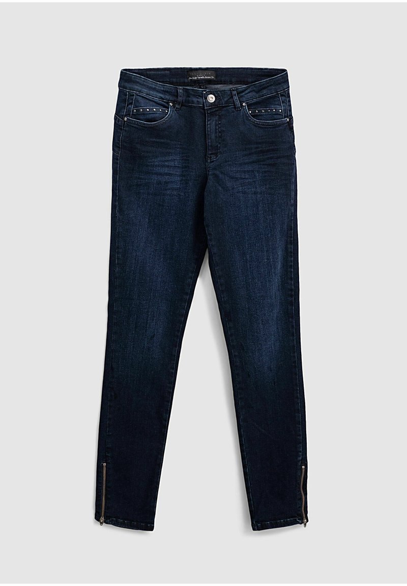 Tmavě modré džíny z denimu, s úzkým střihem, pěti kapsami a zipovými detaily na kotnících. Tkanina má mírně vybledlý vzhled.