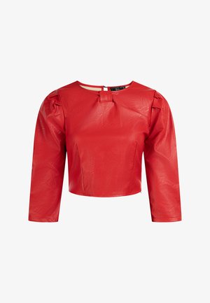 Blouse courte rouge en simili cuir brillant. Dotée de manches longues, d'un col rond et d'un détail avant unique avec un petit rabat.