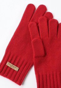 Rote gerippte, gestrickte Handschuhe aus weichem Material, mit einem kleinen braunen Etikett "BELLEMERE NEW YORK" im Bereich des Handgelenks.