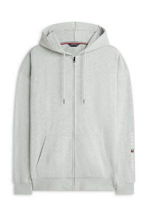 Sweat à capuche gris clair zippé avec cordons, poches avant, poignets côtelés et logo "Tommy Hilfiger" sur la manche droite.