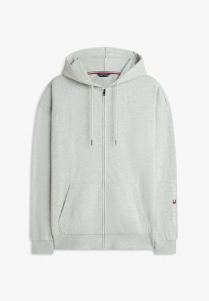 Sudadera con capucha gris claro con cremallera, cordones, bolsillos delanteros, puños acanalados y el logo de "Tommy Hilfiger" en la manga derecha.