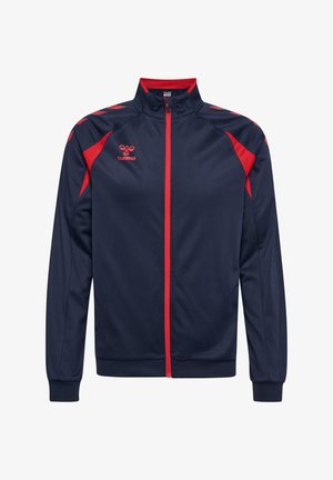 Dunkelblaue Sportjacke mit rotem Reißverschluss, roten Schulterakzenten und einem kleinen roten hummel-Logo auf der linken Brust, mit Stehkragen.