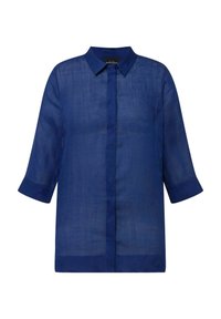 Camisa de lino azul marino con cuello, mangas tres cuartos y corte recto. Tejido ligero y texturizado con un brillo sutil.