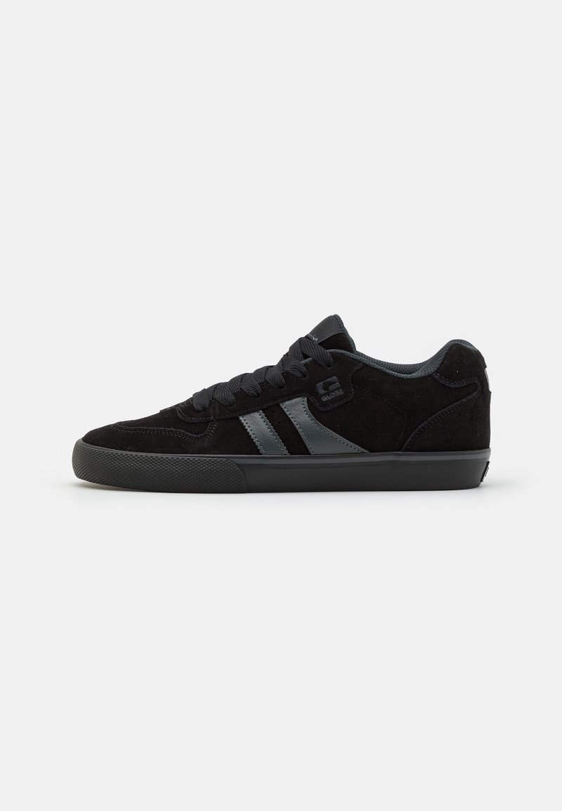 Black suede skate shoes with dark rubber soles, featuring gray side stripes and matching laces, designed for comfort and durability.