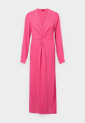 Pink long-sleeve dress with a deep V-neck, gathered twist detail at the waist, and a floor-length streamlined silhouette. Smooth fabric texture.