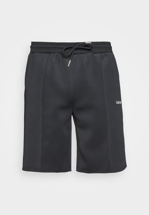 Zwarte shorts gemaakt van een gladde jersey stof. Heeft een elastische tailleband met een trekkoord en een wit logo-detail aan de zijkant.
