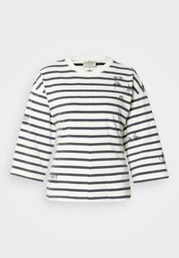 Ριγωτό βαμβακερό t-shirt με ναυτικές και λευκές ρίγες, μανίκια 3/4, στρογγυλή λαιμόκοψη και γραφική λεπτομέρεια με μάτια και κείμενο στα μανίκια.