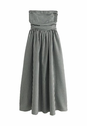 Mouwloze, knielange jurk in een zwart-wit geruit patroon. Gerimpelde tule, elastische tailleband en een vloeiende rok met geplooide textuur.