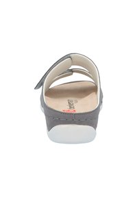 Gray suede back of a sandal with a white sole, featuring two elastic straps for easy wear and a beige cushioned footbed.
