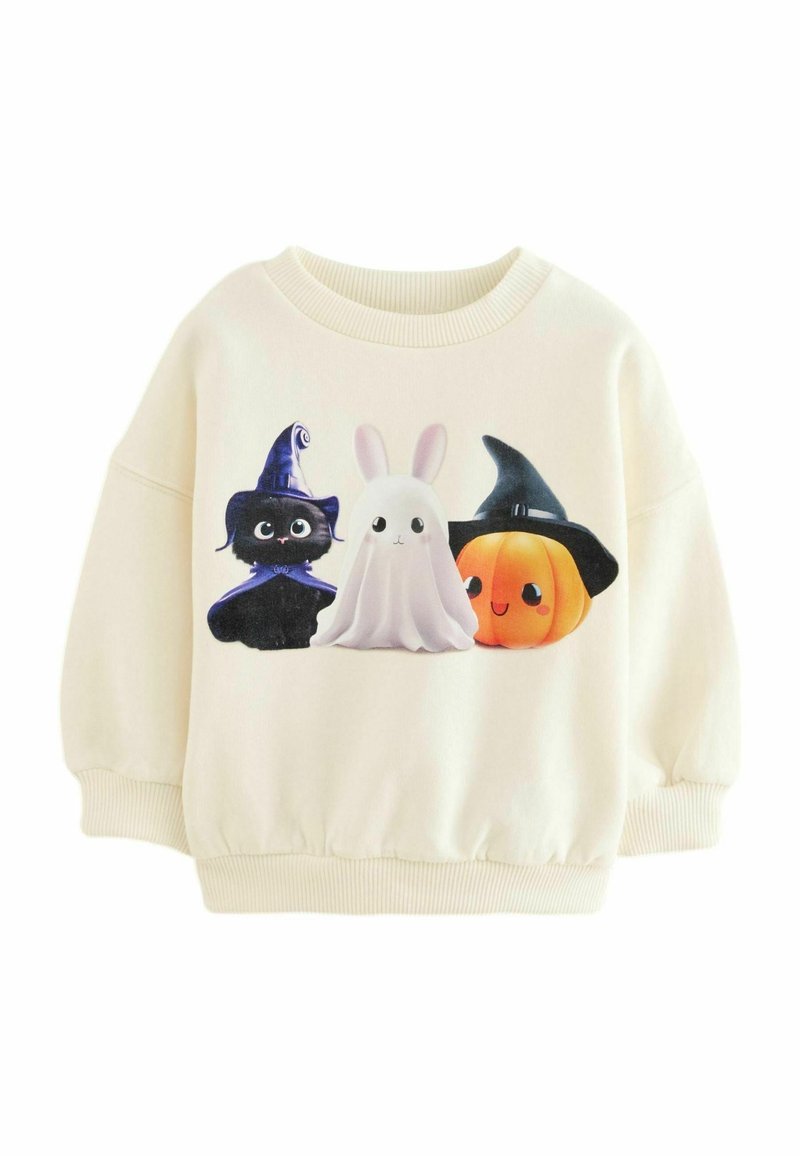 Sweat-shirt crème avec imprimé sur le thème d'Halloween comprenant un chat noir portant un chapeau de sorcière, un lapin fantôme, et une citrouille souriante également coiffée d'un chapeau de sorcière.