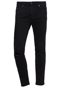 Jean skinny noir avec déchirures usées sur les deux genoux et ourlets effilochés, doté de poches avant et arrière ainsi que d'une fermeture à boutons.