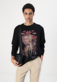Black long-sleeve T-shirt featuring a colorful graphic print of characters from "Star Wars: Episode I – The Phantom Menace."