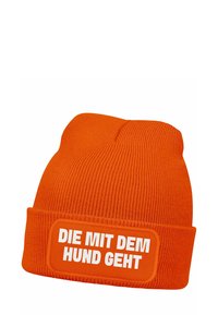 Orange knit beanie with a folded cuff, featuring a rectangle patch that reads "DIE MIT DEM HUND GEHT" in white text. Textured ribbed design.