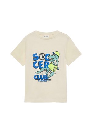 T-shirt pour enfants de couleur crème avec un dinosaure bleu portant une casquette et un maillot, texte "Soccer Club" et un graphique de ballon de football.