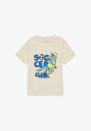 Cremefarbenes Kinder-T-Shirt mit einem blauen Dinosaurier, der eine Mütze und ein Trikot trägt, dem Text "Soccer Club" und einer Grafik eines Fußballballs.