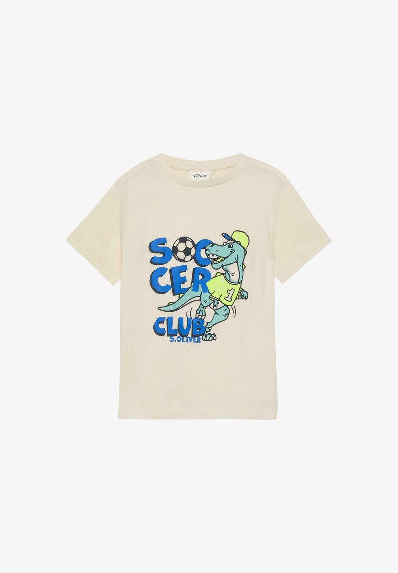 T-shirt pour enfants de couleur crème avec un dinosaure bleu portant une casquette et un maillot, texte "Soccer Club" et un graphique de ballon de football.