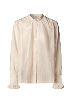 Blusa beige a maniche lunghe con bottoni frontali, colletto tondo, spalle arricciate e polsini arruffati su sfondo bianco uniforme.