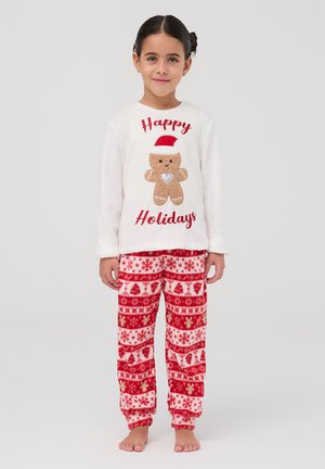 Maglione bianco in pile a maniche lunghe con grafica di pan di zenzero e testo "Buone Feste"; pantaloni in pile rossi e bianchi con motivo di fiocchi di neve e alberi.