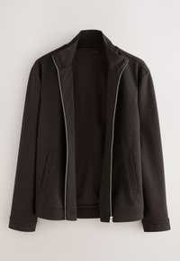 Veste zippée marron foncé avec col montant et poches fendues, devant légèrement ouverte, présentée sur un fond clair uni.